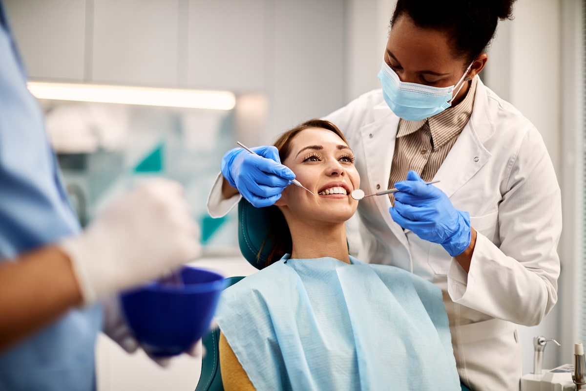 young-smiling-woman-having-dental-exam-at-dentist-2024-12-13-22-13-38-utc (1)-min