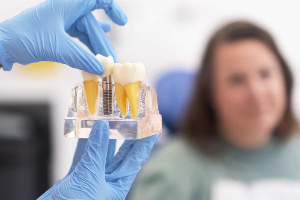 Dental implant model in modern clinic: showing teeth implantation and crown, healthy teeth treatments.