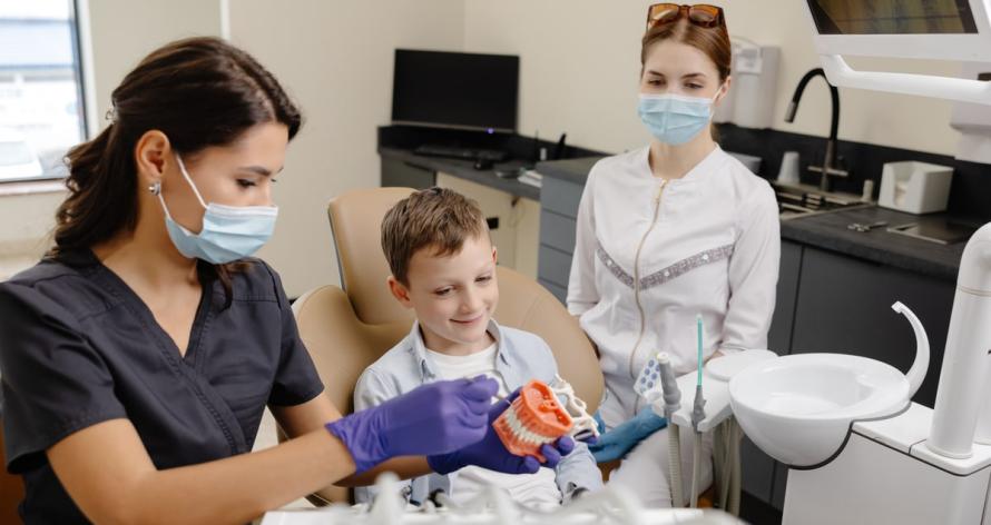 boy-playing-with-teeth-model-at-professional-consu-2025-02-12-03-27-46-utc (1)-min